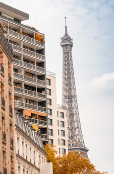 La Tour Eiffel, Paris. Landmark surrounded by trees and buildings in summer.