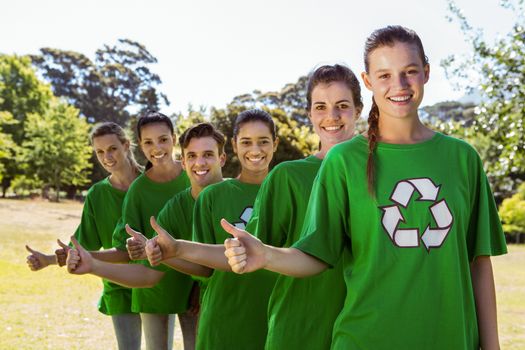 Environmental activists smiling at camera on a sunny day