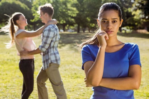 Man being unfaithful in the park on a sunny day