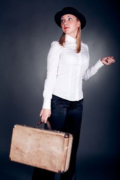 studio shot of gangster styled women with suitcase