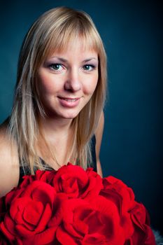 young romantic women with bouquet of red roses