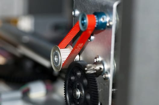 detail of a gear with a timing belt color red