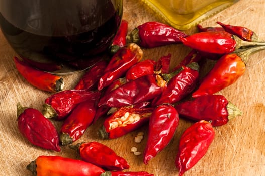 red hot chili peppers on a cutting board with olive oil