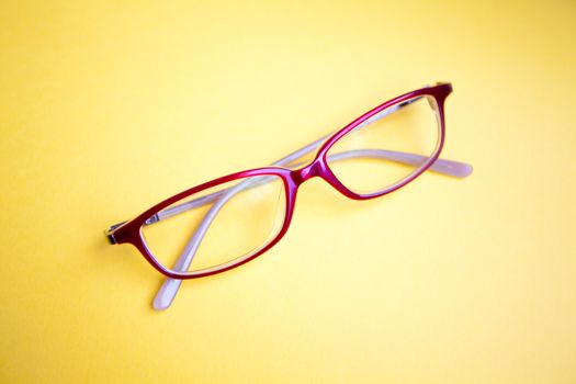 Fashion glasses on yellow background