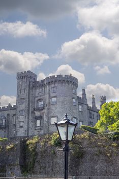 beautiful antique street lamp and riverside view of kilkenny castle in ireland