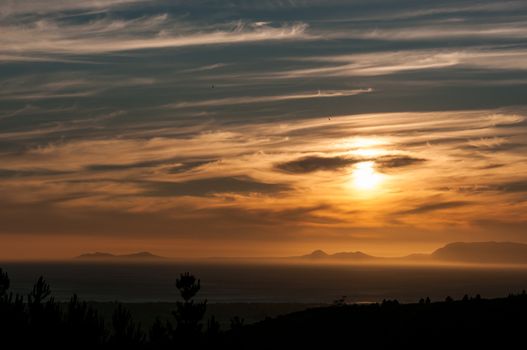 Sun setting across False Bay with Gordons Bay visible in front and Cape Point to the left