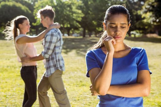 Man being unfaithful in the park on a sunny day