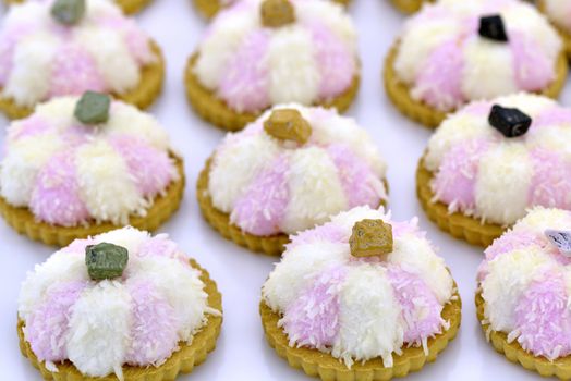 Several coconut cookies with chocolate stripes decorated with chocolate pebble