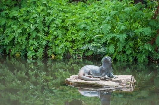 CAPE TOWN, SOUTH AFRICA - DECEMBER 9, 2014: Sculpture of an otter in the Kirstenbosch Botanical Gardens