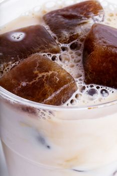 Delicious coffee with ice cubes