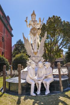 Hindu Goddess Dewi Saraswati Goddess of Knowledge and Wisdom Indonesian Embassy Embassy Row Massachusetts Avenue Washington DC Goddess is the Representative of Bali.  Goddess erected in 2014.  One of the students studying at the Goddess's feet is President Barak Obama when he was a little boy in Indonesia.  Statue built by five Balinese sculptors headed by Nyoman Sudarwa