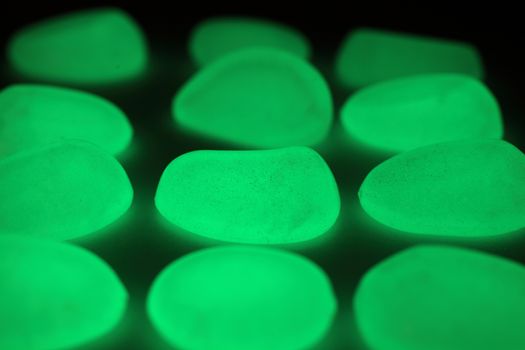 Green fluorescent stones on a mirror.