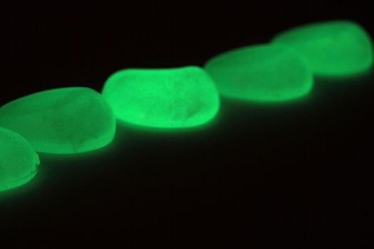 Green fluorescent stones on a mirror.