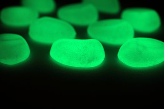 Green fluorescent stones on a mirror.