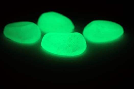 Green fluorescent stones on a mirror.