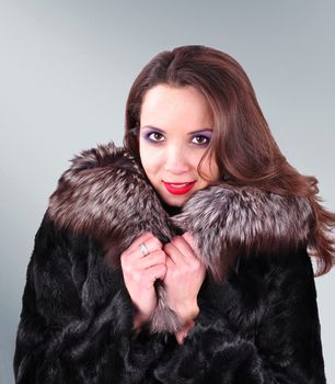 young girl in a fur coat