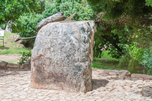 CAPE TOWN, SOUTH AFRICA - DECEMBER 9, 2014: Sundial with inscription Horas Signo Umbra Movente Flores Gigno Luce Fovente  in the Kirstenbosch Botanical Gardens
