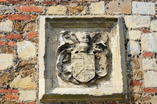 Heraldic stone carving set in wall