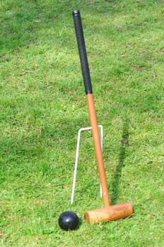 Croquet Mallet leaning against hoop