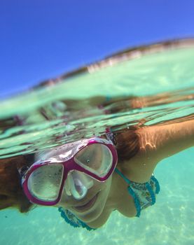 Underwater Portrait of a Yong Woman Snorkeling in Ocean.