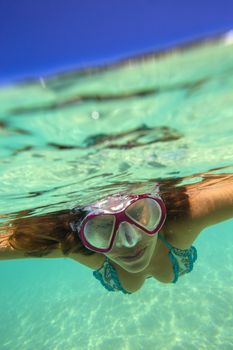 Underwater Portrait of a Yong Woman Snorkeling in Ocean.