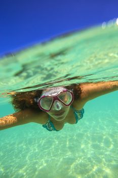 Underwater Portrait of a Yong Woman Snorkeling in Ocean.