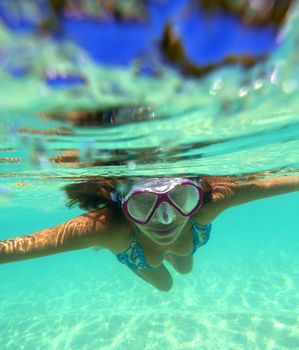 Underwater Portrait of a Yong Woman Snorkeling in Ocean.