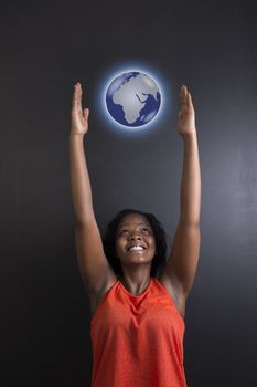 South African or African American woman teacher or student reaching for world earth globe on black background