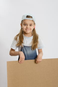 Six year old girl playing and collecting wooden cabinet