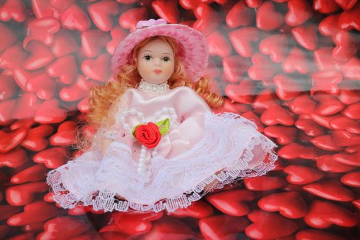 Baby doll on a lot of little red hearts