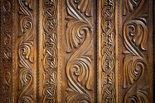 Abstract floral decoration carved on a wood door