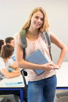 Portrait of happy female student holding digital tablet in college