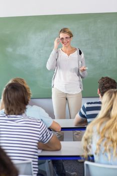 Female teacher teaching students in the class