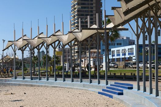 IQUIQUE, CHILE - FEBRUARY 10, 2015: Partly shaded sitting area along the Pacific coast on February 10, 2015 in Iquique, Chile. Iquique is a popular beach town and free port city in Northern Chile.