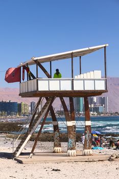 IQUIQUE, CHILE - FEBRUARY 10, 2015: Unidentified person in lifeguard watchtower on Cavancha beach on February 10, 2015 in Iquique, Chile. Iquique is a popular beach town and free port city in Northern Chile.