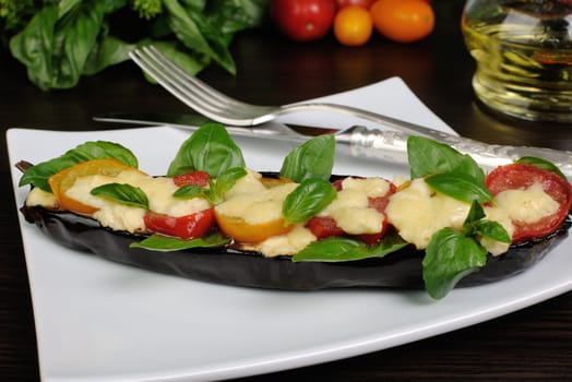 Baked eggplant with tomato cheese and basil