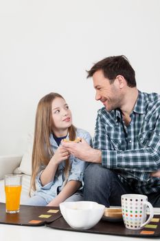 Father having a breakfast with his daughter