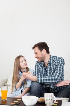 Father having a breakfast with his daughter