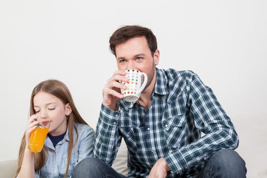 Girl with his father drinking juice