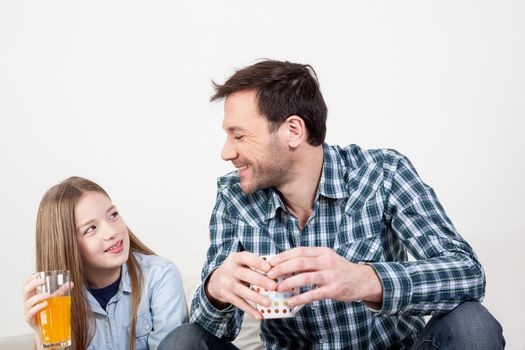 Girl with his father drinking juice