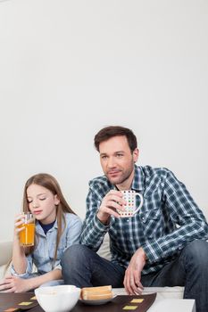 Girl with his father drinking juice