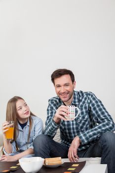 Father with his daughter having a brakfast