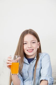 Happy girl drinking a juice