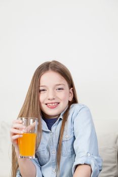 Girl laughing holding a glass with juice