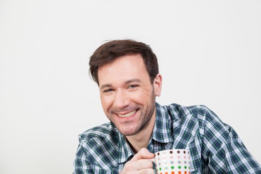 Happy man holding a cupful