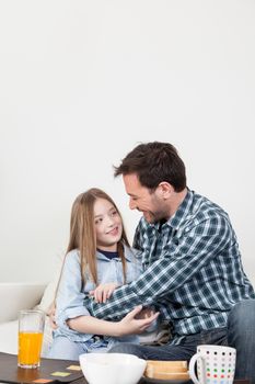 Father and daughter giving a hug in the breakfast