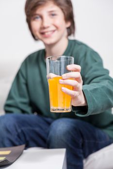Boy holding a glass with juice