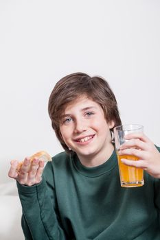 Boy holding a juice and a toast