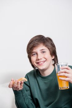 Boy holding a juice and a toast
