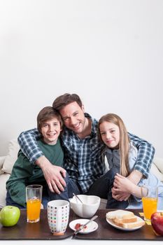 Man having a breakfast with your two childrens